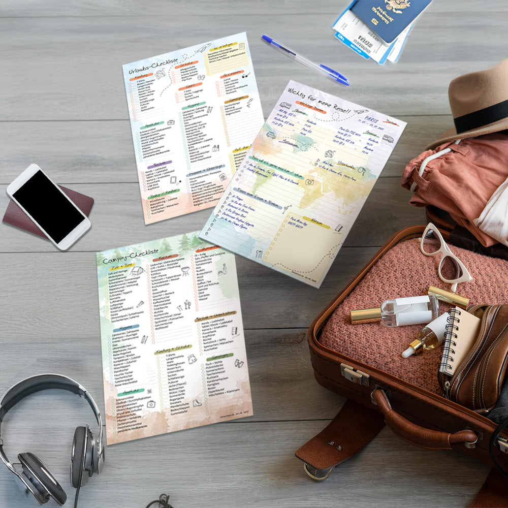 imagebild reiseplaner, ansicht verschiedene reiseplaner auf boden neben einem gepackten koffer